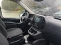 Interior of a 2021 Mercedes-Benz Metris featuring a steering wheel dashboard and front seats with a focus on a digital display and center console