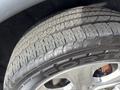 Close-up of a tire from a 2015 Dodge Durango showing tread pattern and shiny alloy wheel rim