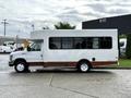 2014 Ford Econoline bus with a white exterior and brown lower trim and large windows on the side