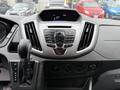 Dashboard of a 2018 Ford Transit displaying a central control panel with buttons for radio and media functions alongside gear shift and various dials for controls