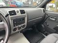 Interior dashboard of a 2011 Chevrolet Colorado featuring a central control panel with radio and climate controls
