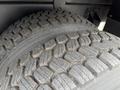 Close-up of a rugged tire on a 2016 Peterbilt 348 showcasing deep treads designed for enhanced traction and stability