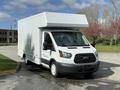 White 2016 Ford Transit box truck with a high roof and front grille showing the Ford logo parked on a paved surface