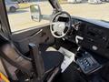 Interior view of a 2017 Chevrolet Express showing the driver's seat steering wheel dashboard and controls
