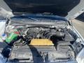 Under the hood of a 2017 Ford F-150 showing the engine components including the air intake the battery and various hoses and belts