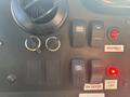 Control panel of a 2012 Ford E-450 featuring switches for lights fans seatbelt status and door ajar indicator