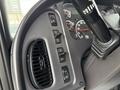 Close-up of the dashboard controls of a 2021 Freightliner M2 106 showing various buttons and dials including air conditioning and lighting controls