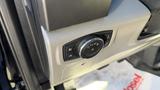 Control panel with a rotary dial and buttons for activating lights in a 2016 Ford F-150