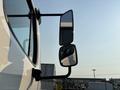 A 2016 Freightliner M2 106 with prominent side mirrors reflecting the surroundings