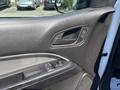 Interior door panel of a 2017 Chevrolet Colorado featuring a window control switch and a door handle