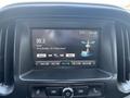 The image shows the dashboard display of a 2017 Chevrolet Colorado with a digital radio interface showing station 99.3 FM and the song by Arctic Monkeys