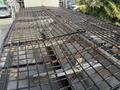 A black metal grid atop a 2013 Freightliner 114SD truck bed with visible rust and a covered interior space