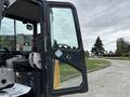 A 2017 John Deere 50G excavator with an open door revealing the driver's seat and controls inside the cabin