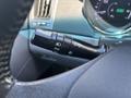 Close-up of a 2014 Hyundai Sonata's steering column controls showing the headlight and turn signal lever