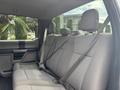 Interior of a 2017 Ford F-150 showing the rear bench seat with seatbelts and fabric upholstery