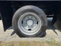 A close-up of a tire from a 2005 GMC C7500 Topkick featuring a silver alloy wheel with visible treads and a TOYO logo on the sidewall