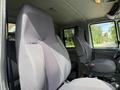 Interior view of a 2011 International 4300 showing the driver's seat and passenger seat with gray upholstery and seatbelts visible