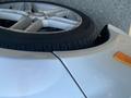 A silver 2013 Mercedes-Benz C-Class with a close-up view of its front wheel and tire