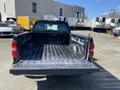 A 2014 GMC Sierra 1500 with an open truck bed showing a lined cargo area and rear tailgate down