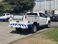 A white 2017 Chevrolet Colorado with blue accents and a tool bed featuring a stainless steel storage compartment and taillights at the rear