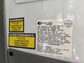 2020 Chevrolet Express van with multiple informational and warning labels attached to the interior wall
