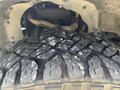 Close-up of a rugged tire tread on a 2021 Ford F-150 showcasing deep grooves and a worn texture