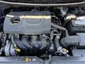 Engine compartment of a 2018 Kia Rio5 showcasing the engine block various hoses and electrical components