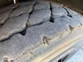 Close-up of a worn tire tread from a 2013 International CE300 showing significant wear patterns and lack of tread depth