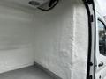 Interior view of a 2017 Ford Transit with a white textured wall and a metal floor