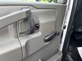 The interior door panel of a 2020 Chevrolet Express featuring a door handle a window control and a manual door lock mechanism