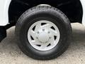 A 2001 Ford F-350 wheel featuring a silver five-spoke rim and a rugged tire with tread visible on the surface
