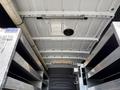 Interior of a 2023 Mercedes-Benz Sprinter 2500 showing the ceiling with lights and metal shelving on the sides