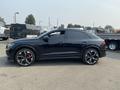 A black 2020 Audi RS Q8 with sleek lines and sporty design features large alloy wheels and red brake calipers