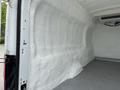 Interior of a 2017 Ford Transit van with white insulation covering the walls and a gray textured floor