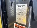 A label on a yellow surface displaying model and serial numbers for a 2020 Chevrolet Express vehicle along with lifting capacity and a warning note