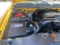 Engine compartment of a 2013 Chevrolet Silverado 1500 showcasing the air intake and battery components