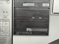 A 2021 Freightliner M2 106 with a Terex hydraulic winch and operation instructions displayed on a metal nameplate