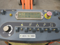 Close-up of the control panel of a 2009 JLG E300AJP with various buttons switches and a digital display for operating the equipment