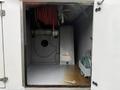 Interior view of a storage compartment in a 2014 International TerraStar displaying hoses and equipment for utility purposes