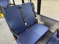 Two blue bus seats with safety belts installed in a public transportation vehicle interior