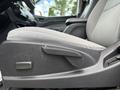 Close-up of the driver's side seat adjuster lever in a 2018 Chevrolet Colorado with a gray fabric seat and armrest