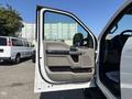 A 2019 Ford F-550 truck with an open door showcasing the interior features including the door panel and handle
