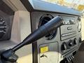 Interior view of a 2008 Ford F-550 showing the gear shift lever and dashboard controls including a speedometer and audio system buttons