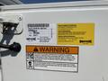 A 2017 Chevrolet Colorado with a warning label and maintenance information on its side panel