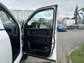 A 2016 RAM 1500 with the driver's side door open showcasing the interior door panel and window switch