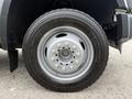 Close-up of a silver wheel from a 2008 Ford F-450 SD featuring a Michelin tire and visible lug nuts