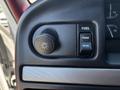 Close-up of the dashboard controls in a 1995 Ford F-250 showing the headlight switch fuel gauge and front rear control buttons