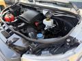 Engine compartment of a 2019 Mercedes-Benz Sprinter featuring the engine air intake system coolant reservoir and various hoses and components