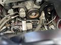 2015 Jeep Grand Cherokee engine showing belts pulleys and various components including a starter motor and hoses