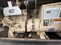 A 2005 Katolight SED60FPJ4 generator with a control panel featuring buttons and indicators, showing a warning label and specifications on the side